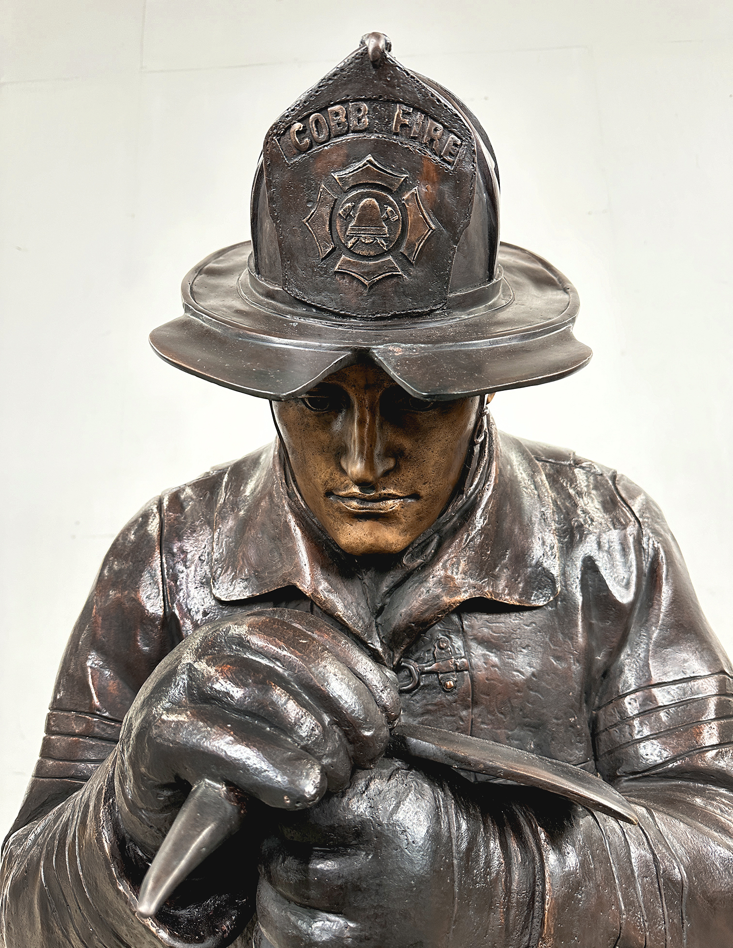 Complete Kneeling Firefighter Custom Bronze Sculpture exclusively designed and produced by Metropolitan Galleries Inc